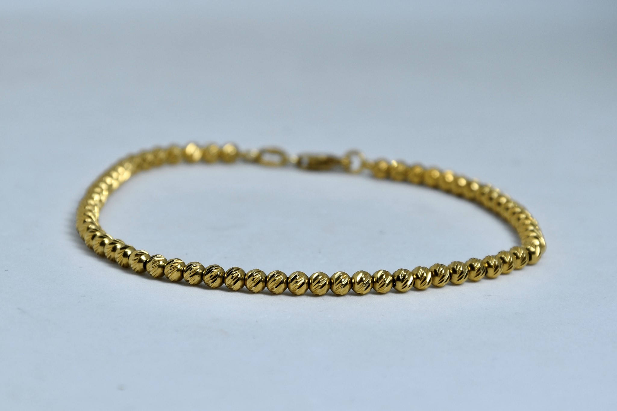 Immagine di BRACCIALE PALLINE SFACETTATE ORO GIALLO